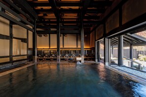 A spacious indoor area with a polished floor, wooden beams, and large windows. - Hotel Sierra Resort Hakuba (Hakuba)