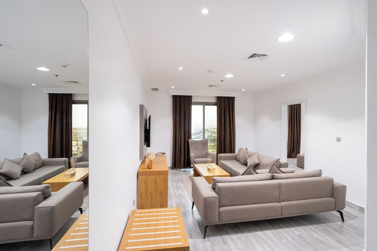 A modern living room with a sofa, coffee table, and a wooden side table.