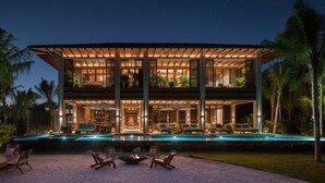 A modern two-story house with a swimming pool, outdoor seating, and a fire pit. - Rosewood Mayakoba (Playa del Carmen)