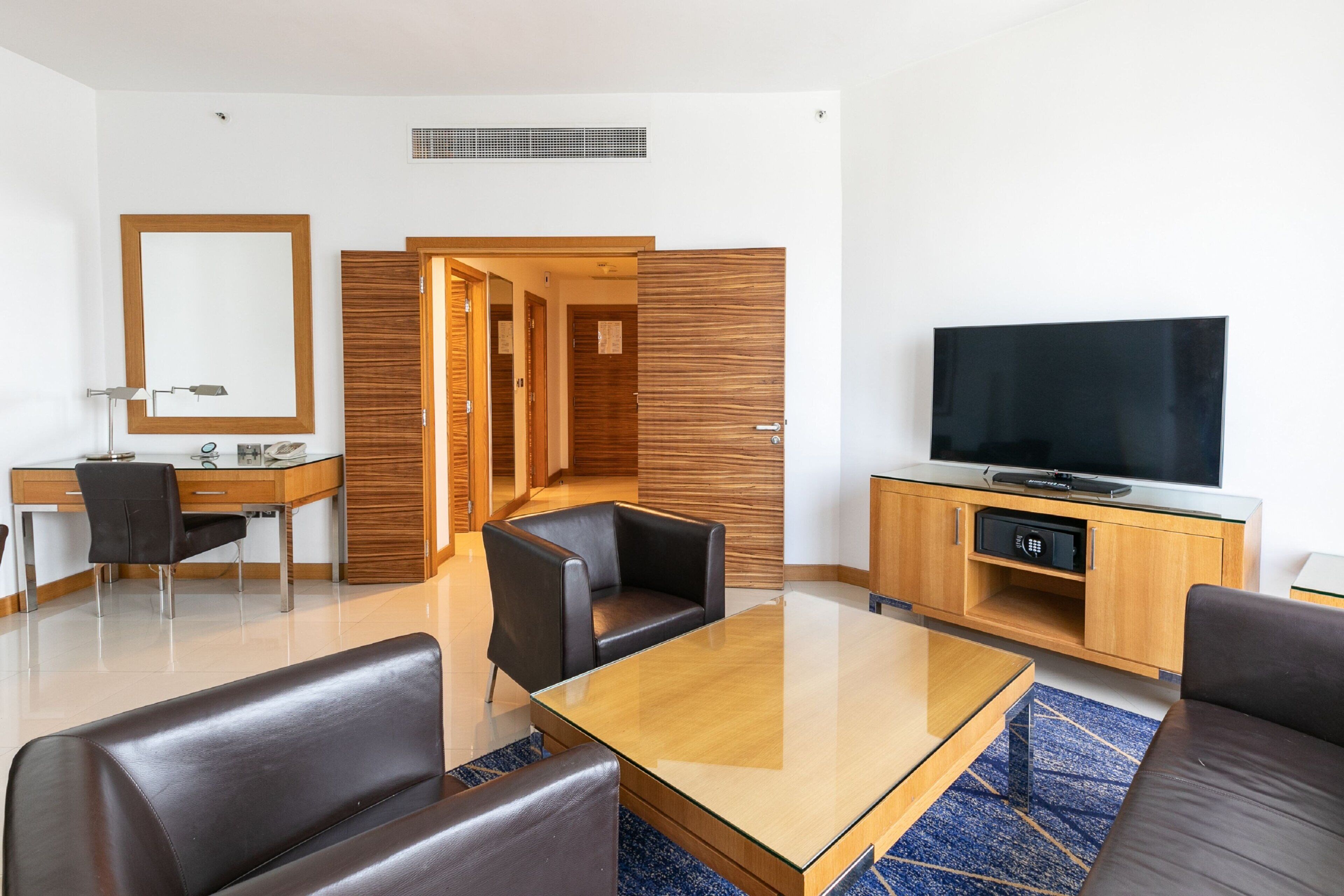 suite, 1 bedroom, non smoking - complimentary shuttle service to dubai mall and kite beach | living area | 32-inch lcd tv with satellite channels, tv