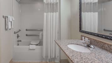 Shower, designer toiletries, hair dryer, towels