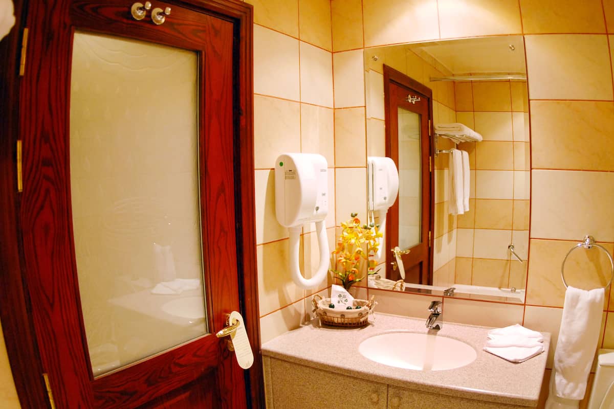 deluxe suite | bathroom | hair dryer, bathrobes, slippers, towels