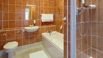 A bathroom with a toilet, sink, bathtub, and shower.
