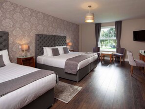 Desk, iron/ironing board, bed sheets