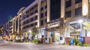 Un hôtel à étages, doté d’une entrée imposante et d’une enseigne indiquant qu’il s’agit d’un hôtel Royal Palm.