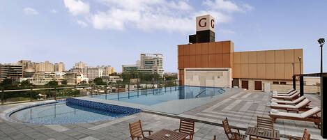 Alberca al aire libre y camastros