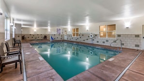 An indoor swimming pool with clear water, surrounded by a tiled wall and a wooden deck. - Comfort Inn Saint George North (St. George)