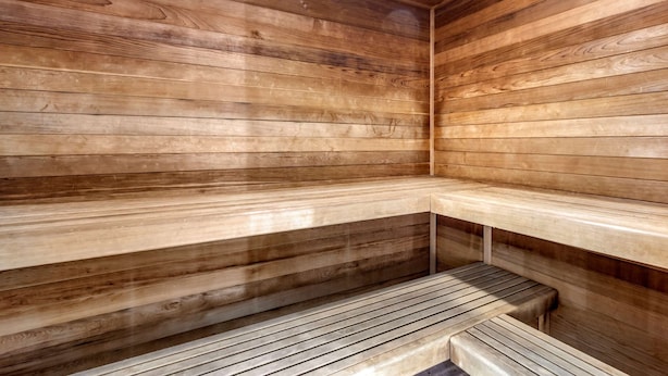A wooden sauna with benches and a sloped floor. - Comfort Inn Saint George North (St. George)