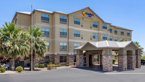 A Comfort Inn hotel with a stone facade, multiple windows, and a covered entrance. - Comfort Inn Saint George North (St. George)