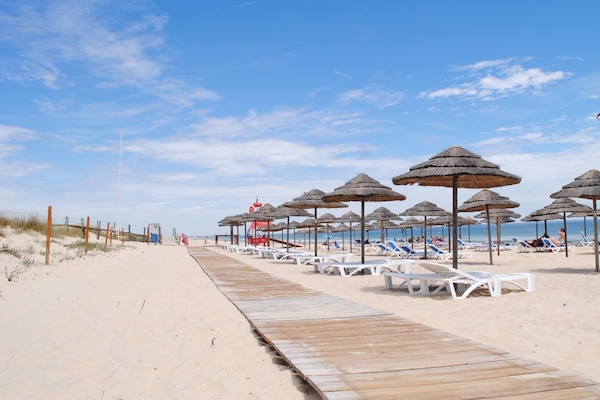 Beach nearby, white sand, beach volleyball