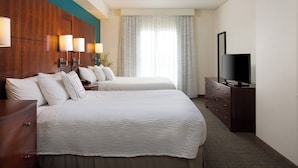A hotel room with two beds, a TV, a dresser, and a window with curtains. - Residence Inn by Marriott Kansas City Airport (Kansas City)