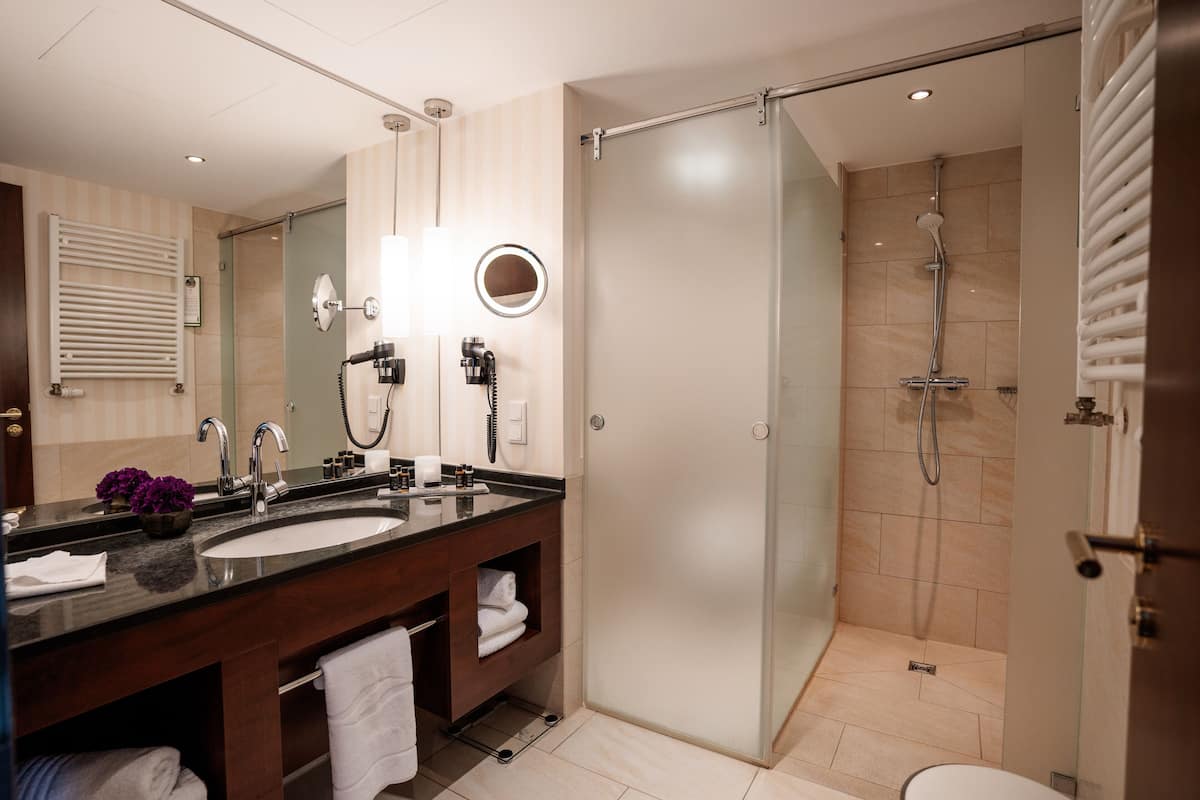 deluxe suite, 1 king bed | bathroom | free toiletries, hair dryer, towels