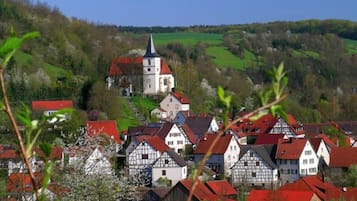 A traditional European village with timber-framed houses and a church.