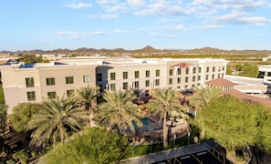 Experience the serene atmosphere of this hotel, surrounded by a lush garden and a swimming pool, with breathtaking views of the desert landscape and distant mountains.