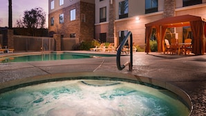 A hotel pool area with a hot tub, lounge chairs, and a covered seating area. - Hilton Garden Inn Phoenix North Happy Valley (Phoenix)