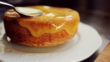 A cake with caramel sauce on a white plate.