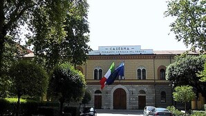 A building with a sign reading "CASERMA" and a large flag. - Hotel Italia (Foligno)