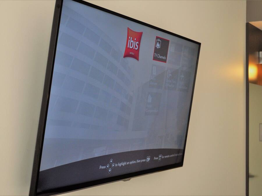 A hotel TV screen displaying the ibis logo and TV channels.