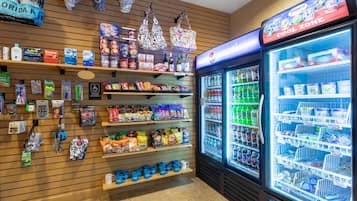 A store with shelves stocked with snacks, beverages, and household items.