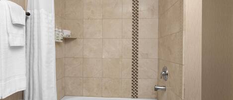 A modern bathroom with a bathtub, a shower curtain, and a towel rack.