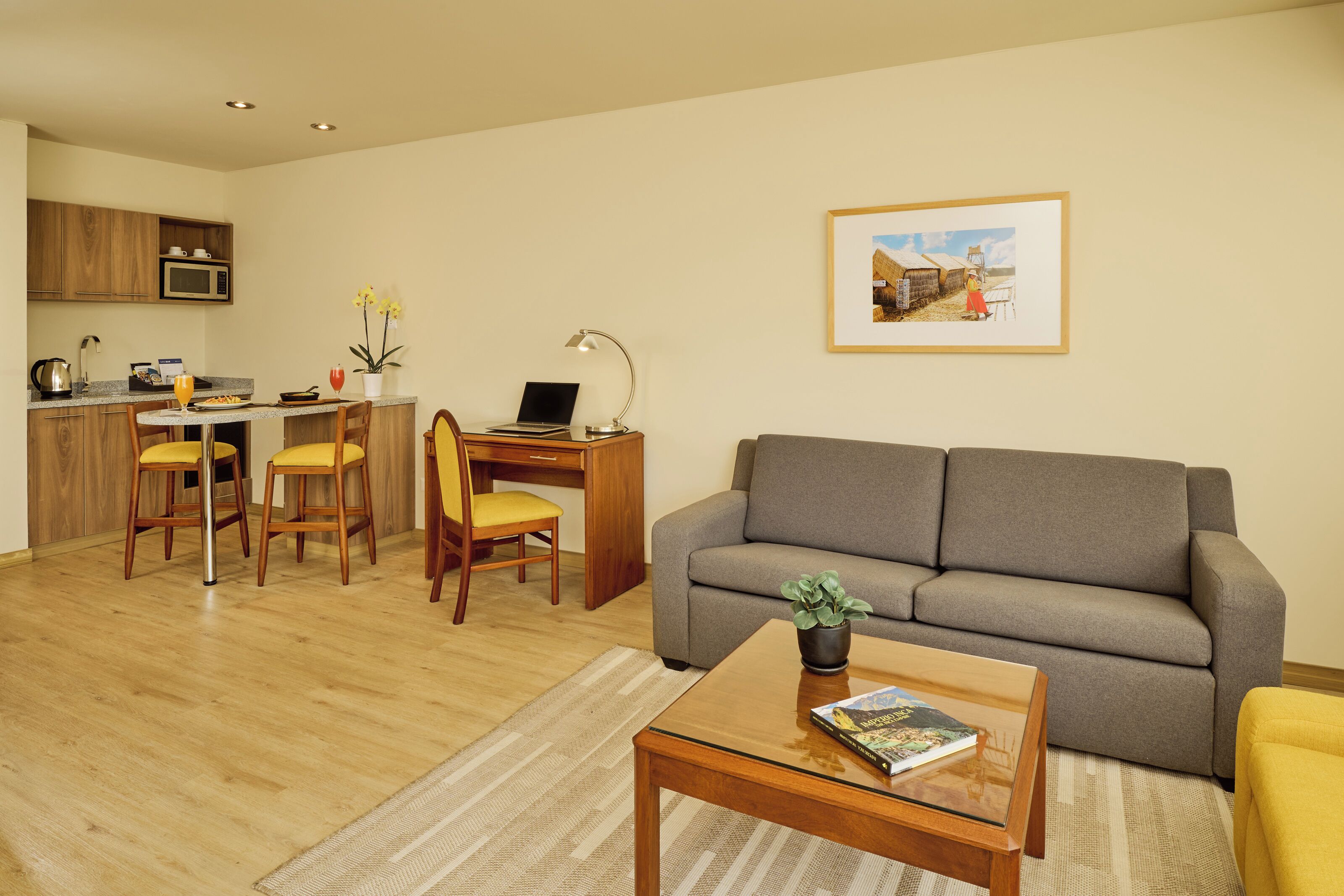 A modern living space with a kitchen, dining area, and a sofa.