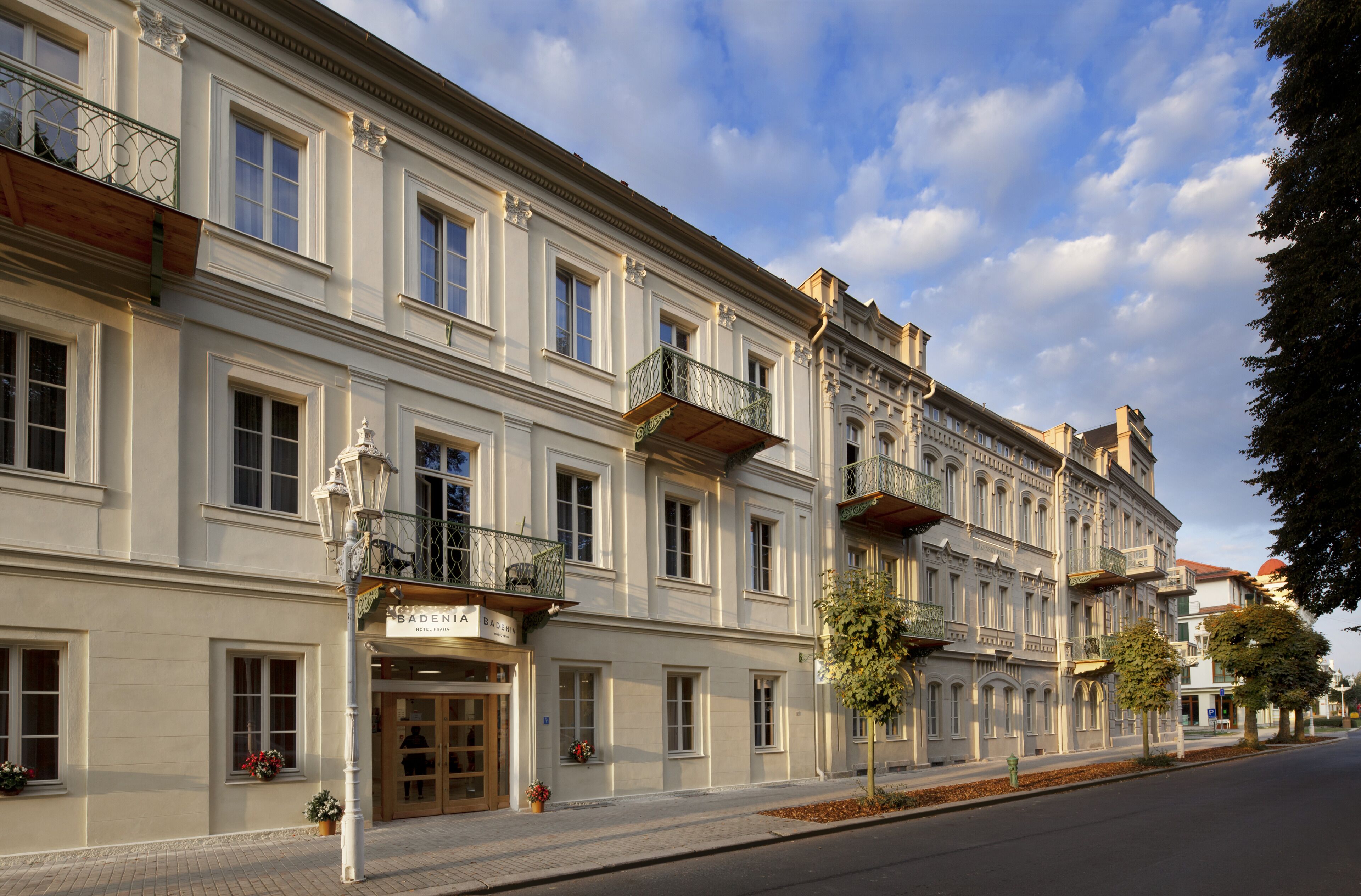 A historic building with a bakery on the ground floor, multiple balconies, and classic architecture.
