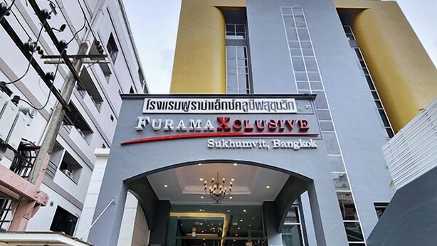 A modern building with a sign reading "Furama Xclusive Sukhumvit, Bangkok". - FuramaXclusive Sukhumvit (Bangkok)