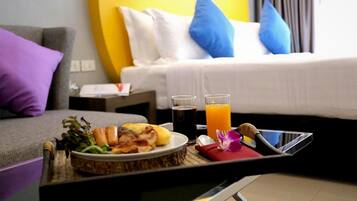 A breakfast tray with food and drinks on a table in a hotel room.