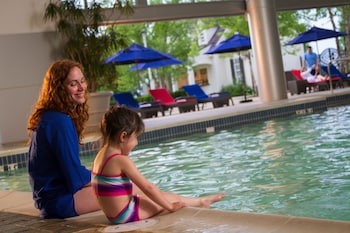 Indoor pool, open 8:00 AM to 10:00 PM, pool umbrellas, sun loungers at Gaylord National Resort & Convention Center