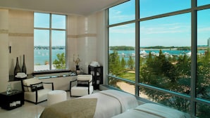 Une chambre moderne dotée d’une grande fenêtre donnant sur une marina et sur l’eau.