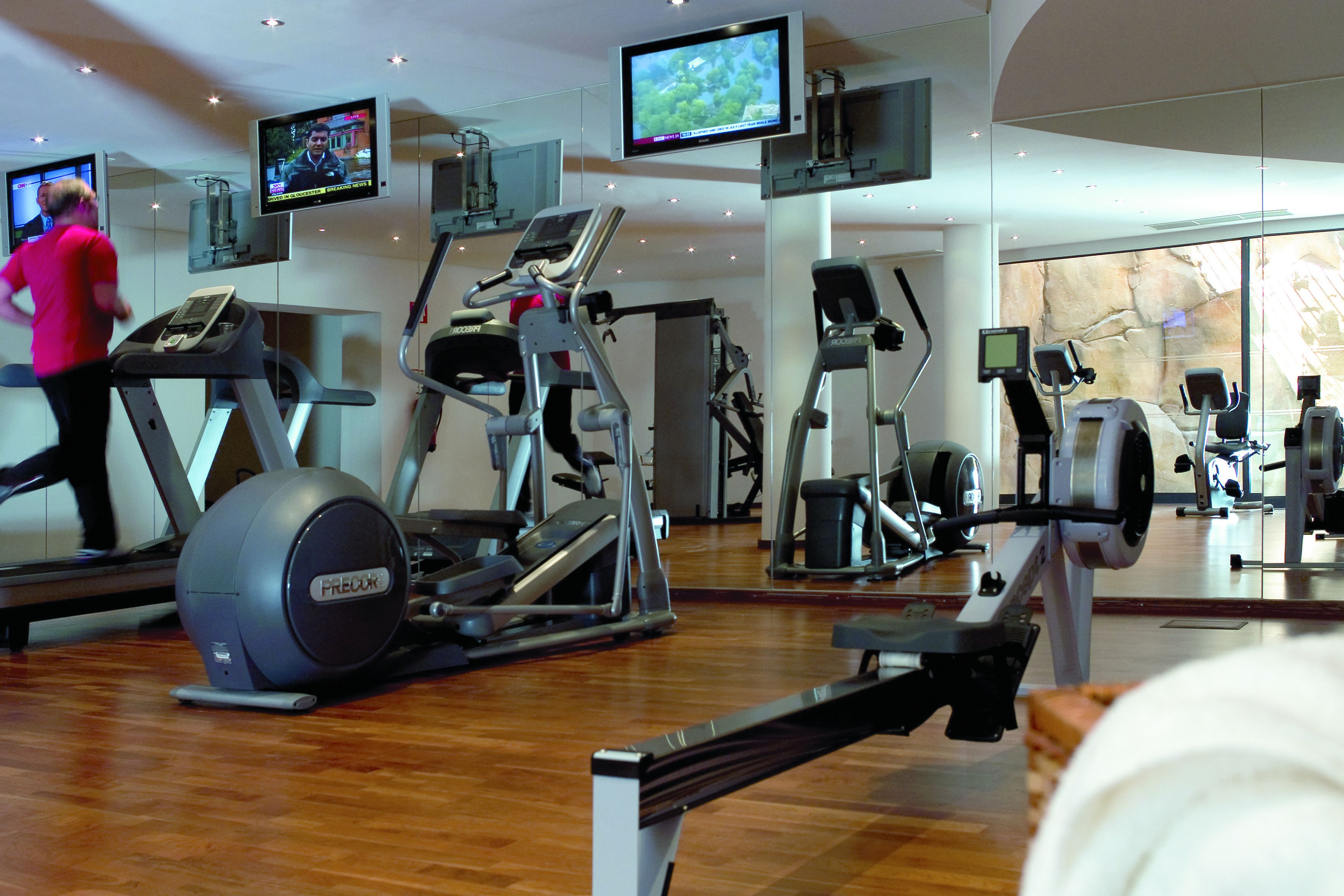 A gym with treadmills, elliptical machines, and stationary bikes.