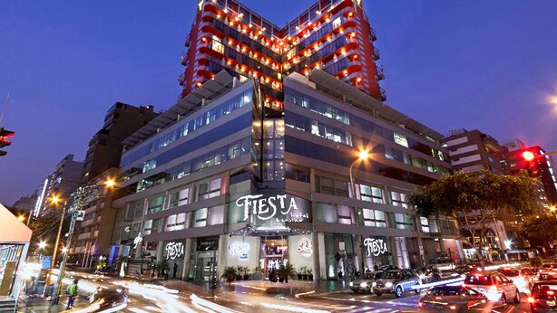 A multi-story building with a prominent 'Fiesta' sign, indicating a hotel or restaurant. - Thunderbird Fiesta Hotel & Casino (Lima)