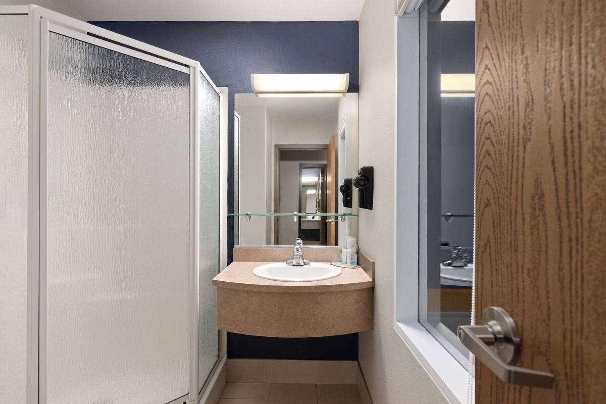 suite, 1 king bed with sofa bed, non smoking | bathroom | combined shower/bathtub, free toiletries, hair dryer, towels