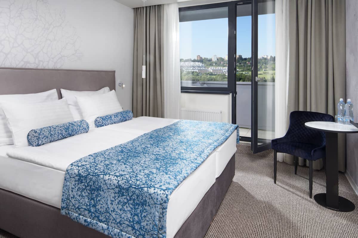 deluxe double or twin room (unlimited spa access) | in-room safe, desk, laptop workspace, blackout curtains