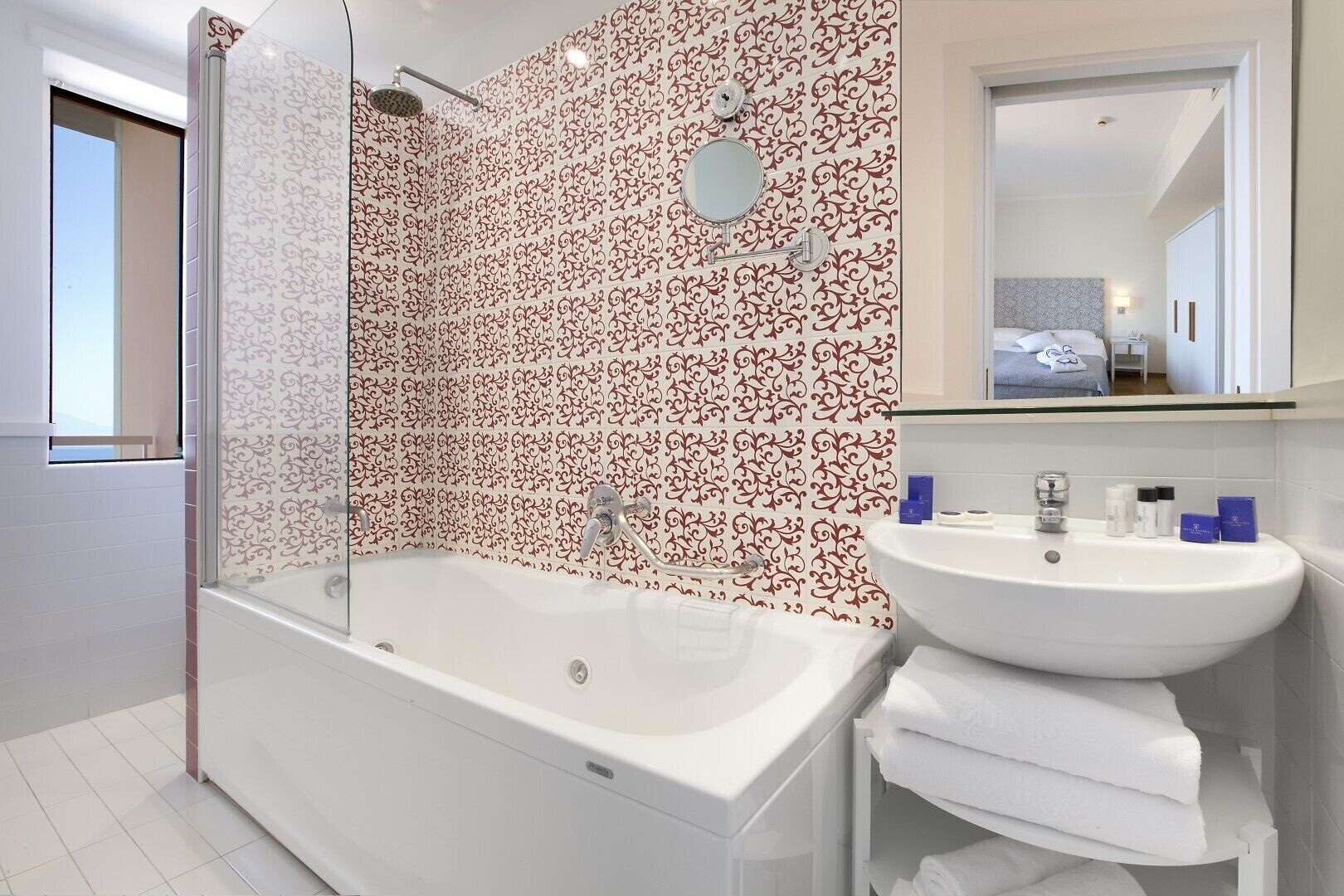 A modern bathroom with a bathtub, a sink, and a shower.