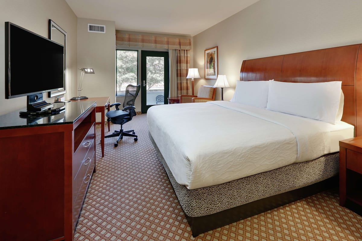 Premium bedding, desk, laptop workspace, blackout drapes
