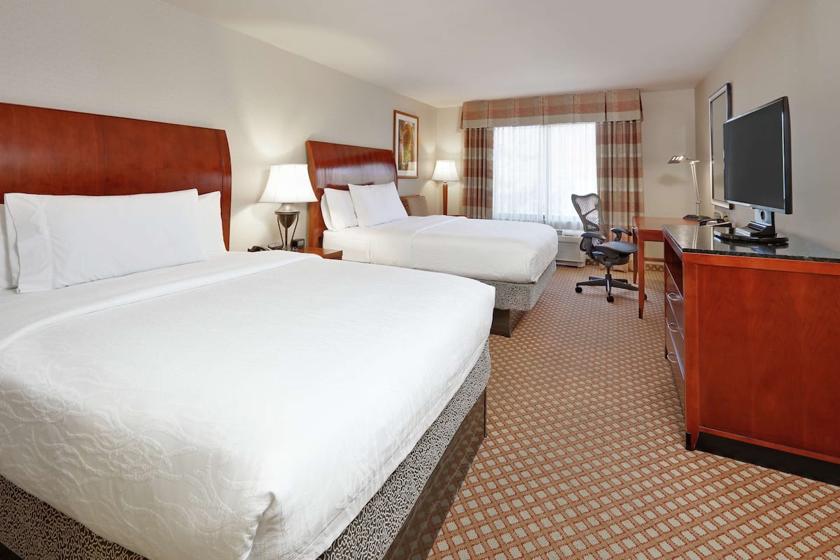 Premium bedding, desk, laptop workspace, blackout drapes