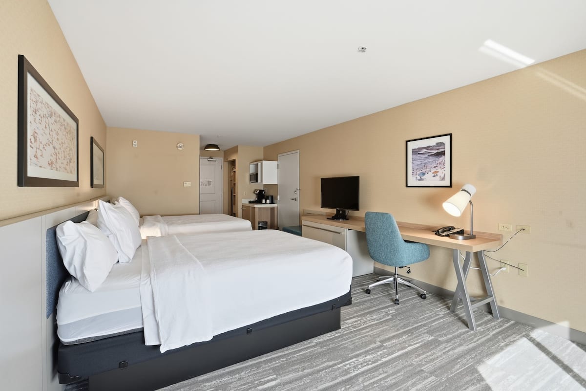 Premium bedding, desk, laptop workspace, blackout drapes