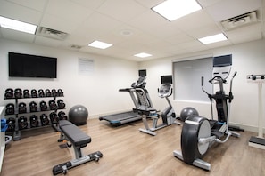 A fitness center with treadmills, elliptical machines, a bench, dumbbells, and a stationary bike. - Holiday Inn Express & Suites Phoenix - Glendale Sports Dist by IHG (Glendale)