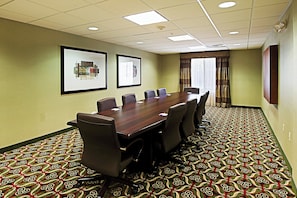 A conference room with a long table, six chairs, framed artwork on the walls, and patterned carpet. - Holiday Inn Express & Suites Phoenix - Glendale Sports Dist by IHG (Glendale)