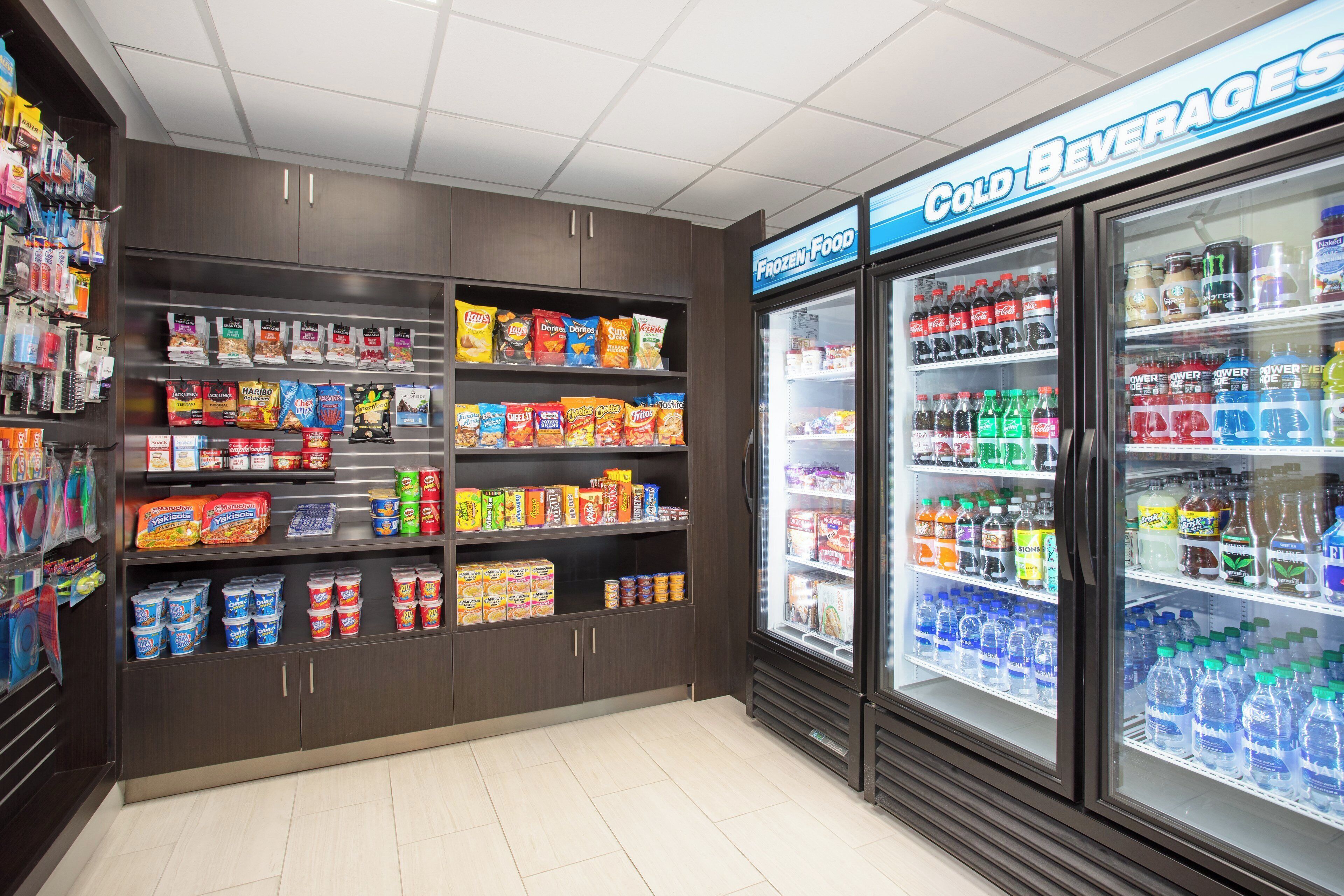 A convenience store with shelves stocked with snacks, drinks, and other items.