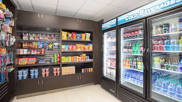 A convenience store with shelves stocked with snacks, drinks, and other items.