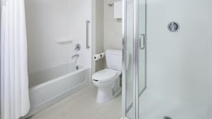 A modern bathroom with a glass-enclosed shower, a white toilet, and a bathtub. - Holiday Inn Express and Suites Ontario Airport by IHG (Ontario)
