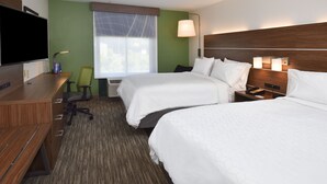 A hotel room with two beds, a desk, a chair, a TV, and a window with a view.