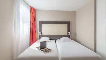 A hotel room with two beds, a large window with sheer curtains, a headboard, and a small table with a board game.