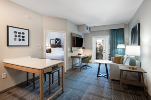 A hotel room with a bed, a desk, a chair, a table, and a TV. - Staybridge Suites Phoenix - Glendale Sports Dist by IHG (Glendale)