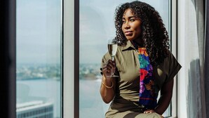 A person sitting by a window with a view of a cityscape. - Renaissance® Boston Seaport District (Boston)