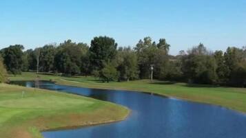 Enjoy golfing on our well-manicured course surrounded by lush vegetation and a serene pond.