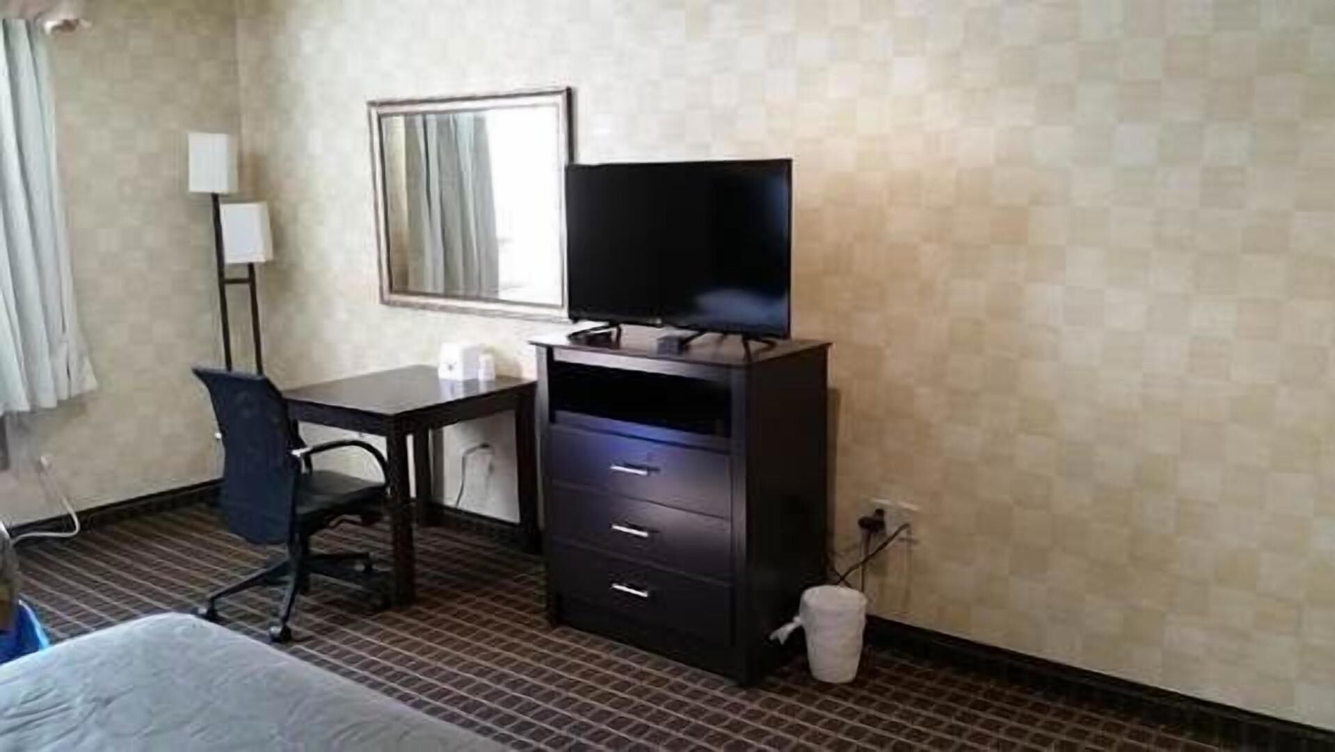 Desk, laptop workspace, blackout drapes, iron/ironing board
