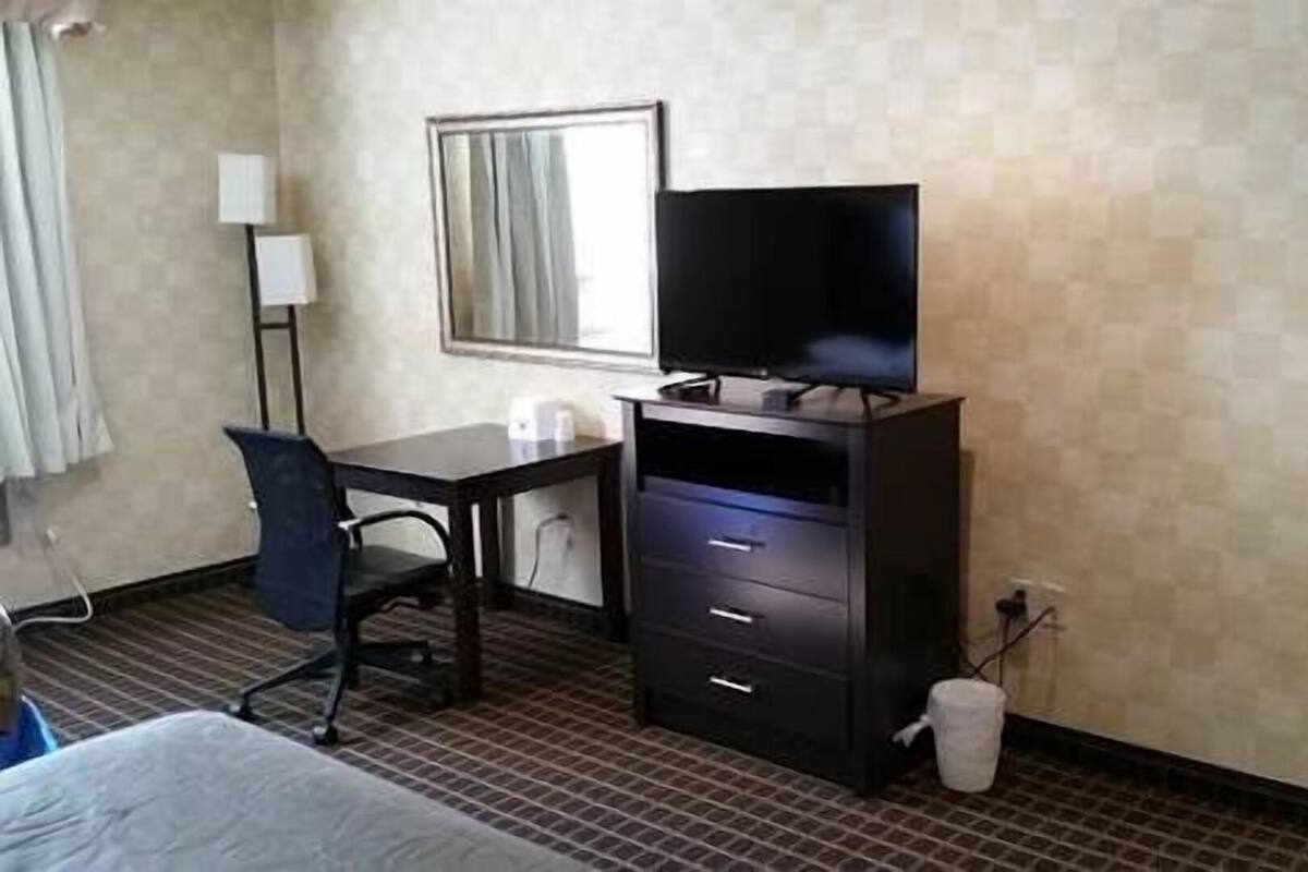 Desk, laptop workspace, blackout drapes, iron/ironing board